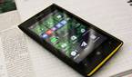 A photo of a Windows Phone sitting on a notebook