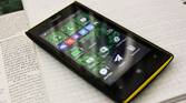 A photo of a Windows Phone sitting on a notebook