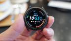 Samsung Galaxy Watch 3 held in a hand with the time and other complications.