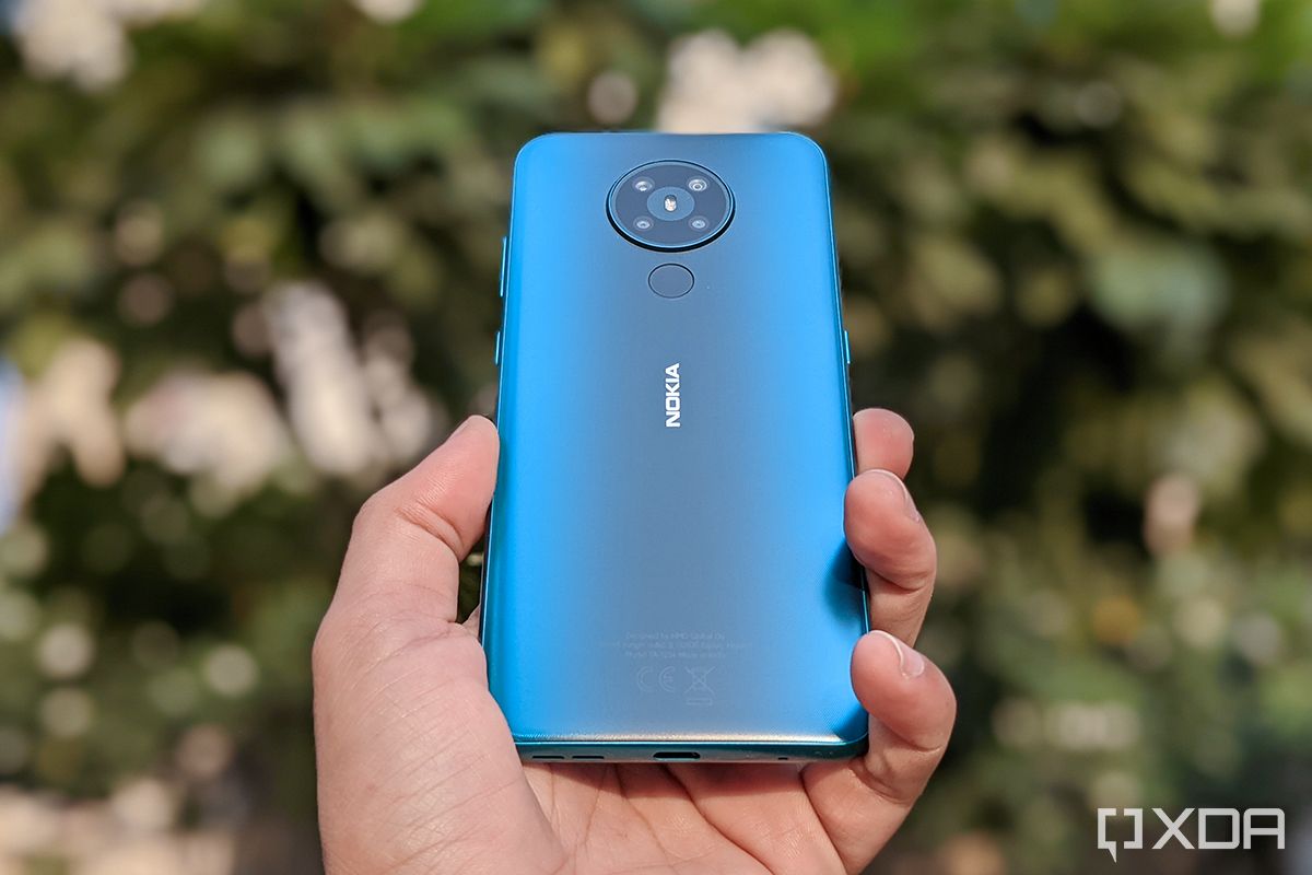 Nokia 5.3 in hand with blurred backhround