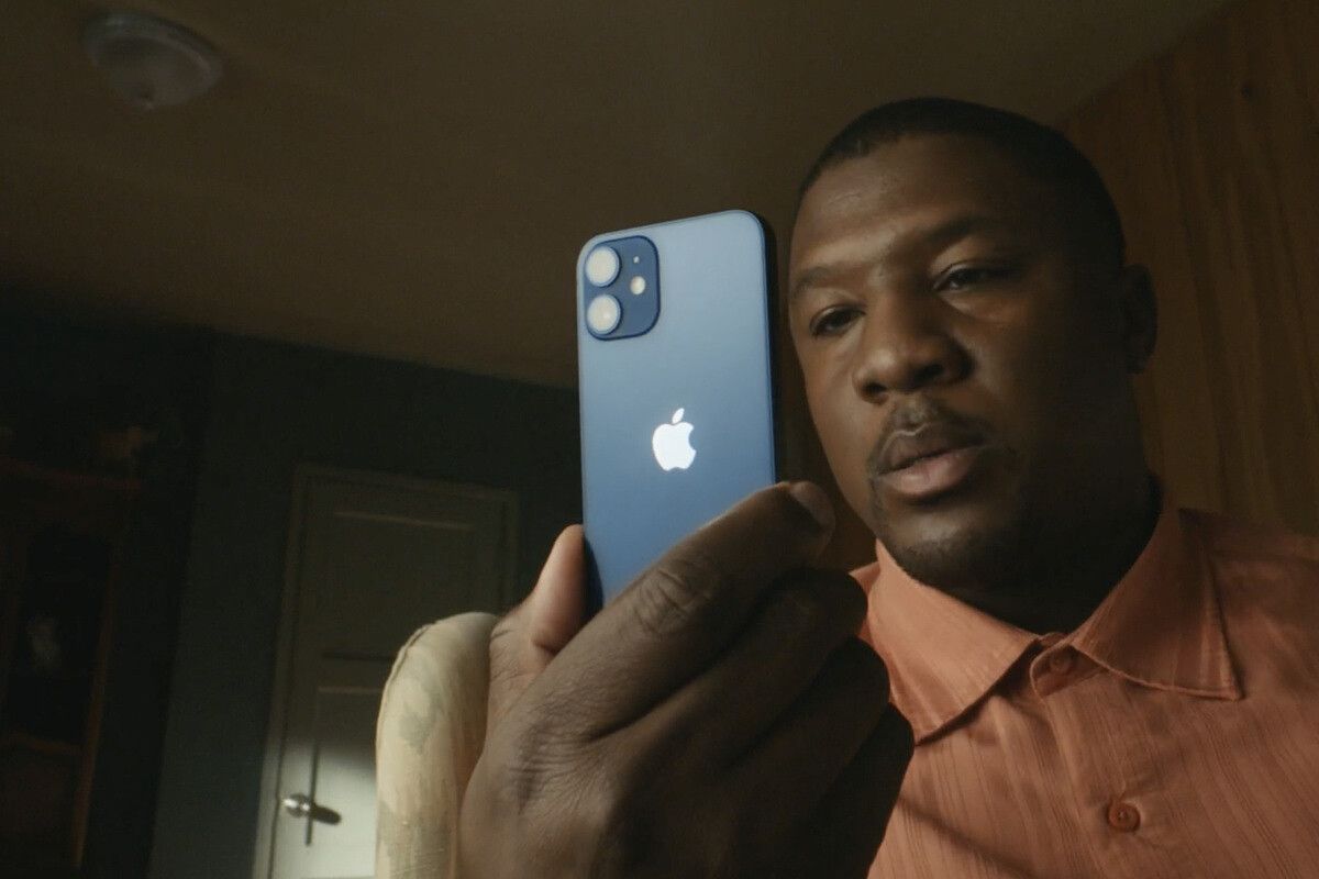 iPhone 12 Mini looking very small in the hands of a consumer.
