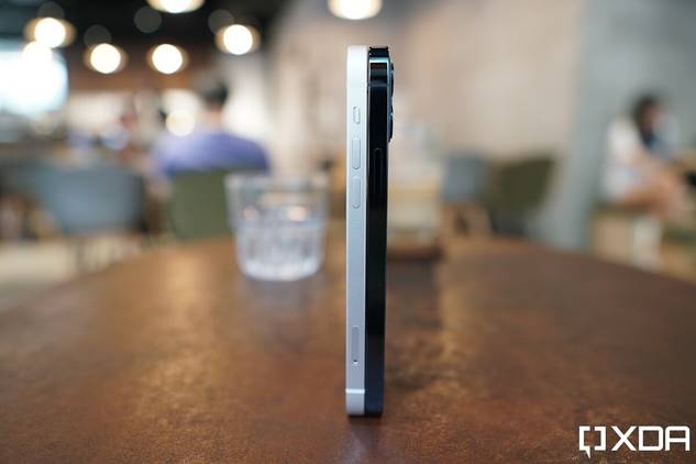 Apple iPhone 12 White and the Apple iPhone 12 Pro Pacific Blue standing upright on a table side by side