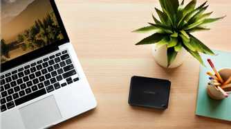 wd easystore 4tb hard drive on a desk with plant and computer
