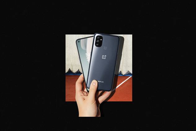 OnePlus Nord N100 in hand on black background