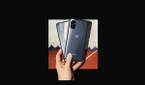 OnePlus Nord N100 in hand on black background