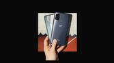 OnePlus Nord N100 in hand on black background