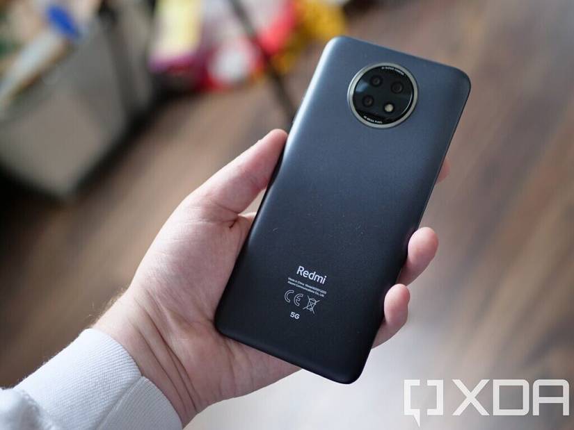 The Redmi Note 9T's back panel, with the device held in hand
