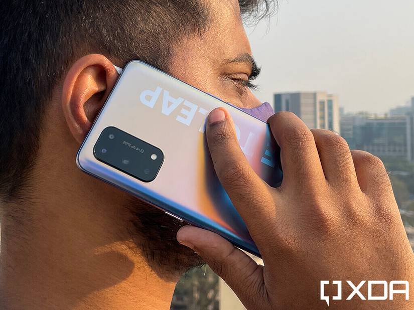Person holding Realme X7 Pro in hand on a phone call