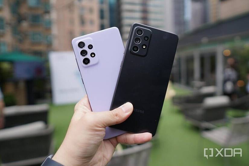 Samsung Galaxy A52 5G in black and Purple held out in hand