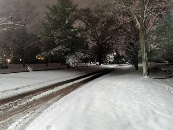 Night shot of a snowy landscape and road