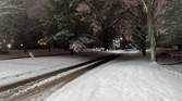 Night shot of a snowy landscape and road