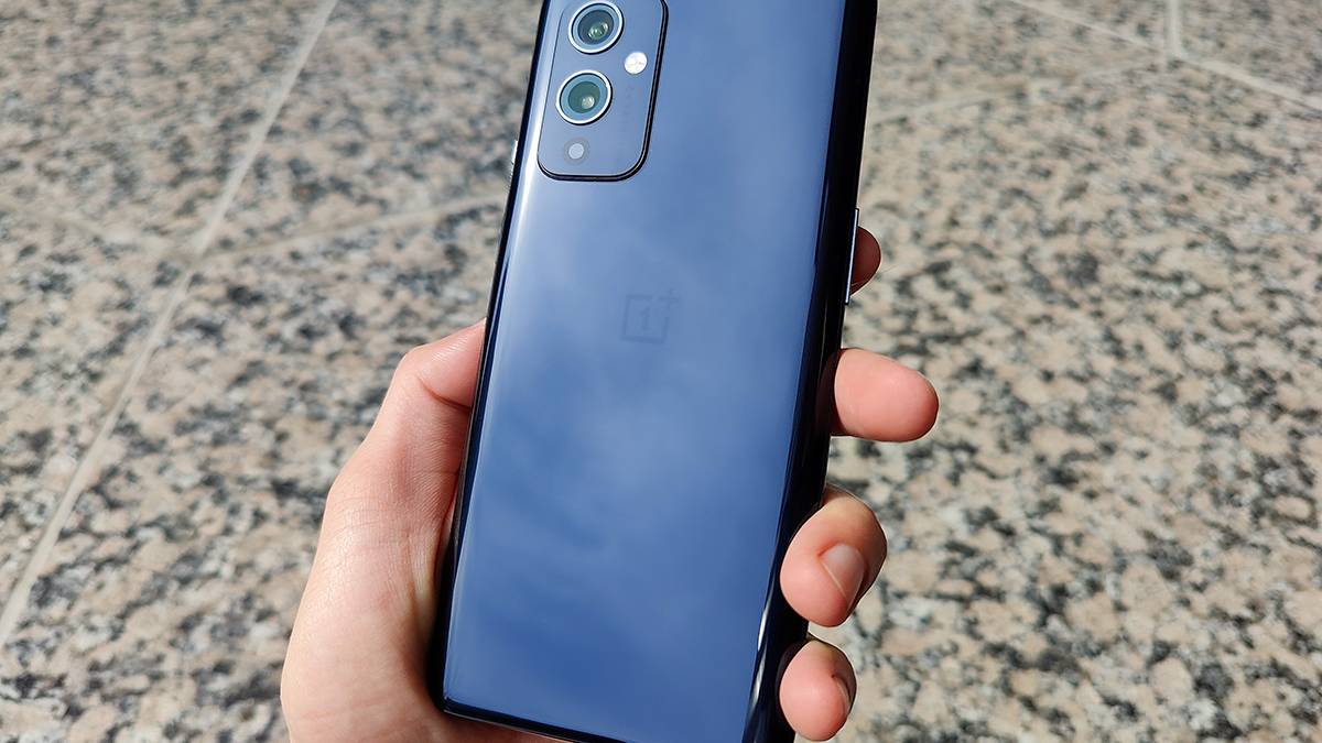 OnePlus 9 in hand showing off Astral Black back color