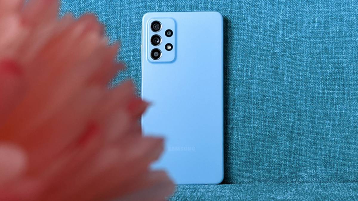 Samsung Galaxy A52 4g in Awesome blue on blue sofa