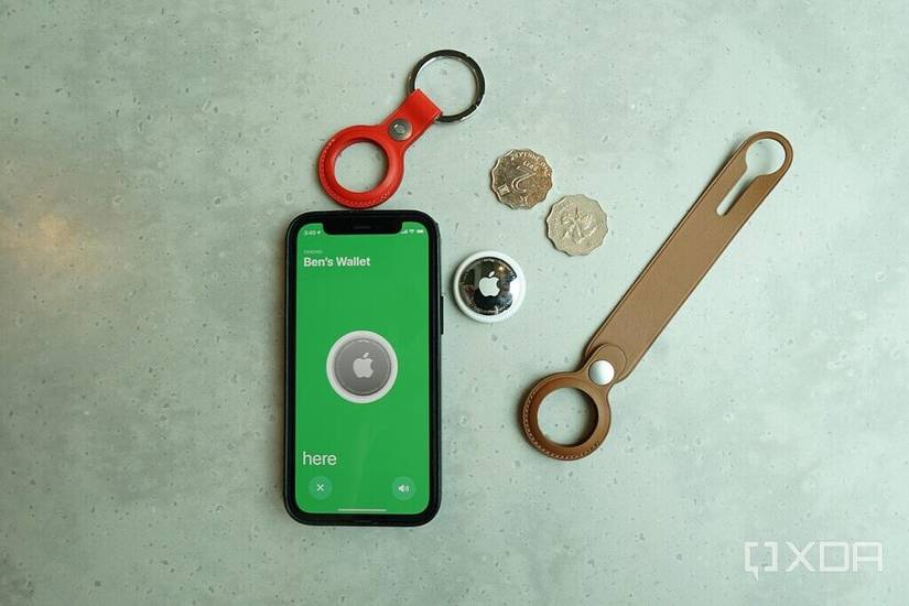 An AirTag with an Apple iPhone 12 and some accessories