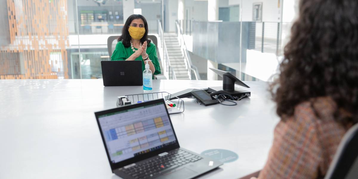 Two users using ThinkPad and Surface Laptop