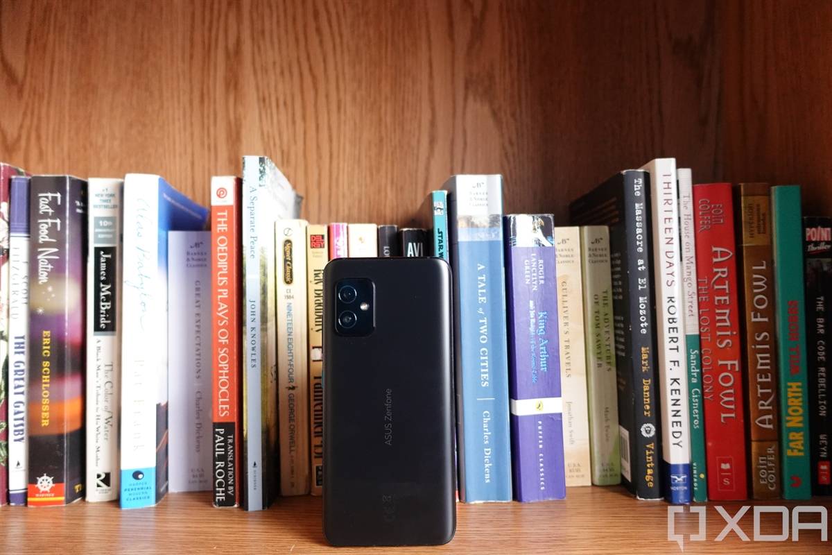ASUS ZenFone 8 in front of books on a bookshelf
