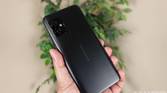 ASUS ZenFone 8 held up with a plant in the background