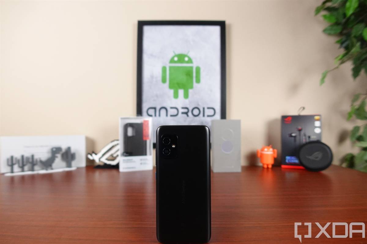 ASUS ZenFone 8 on a table in front of tech gear