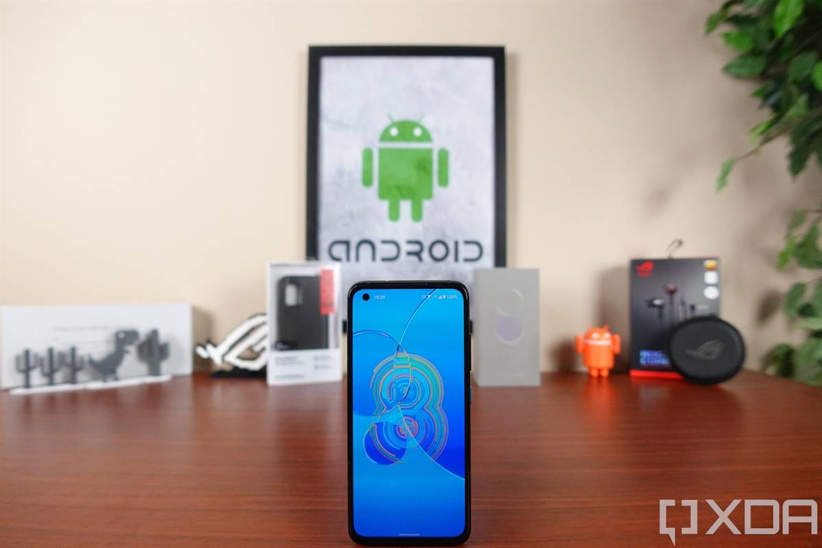 ASUS ZenFone 8 on a table in front of tech gear