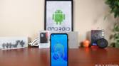 ASUS ZenFone 8 on a table in front of tech gear