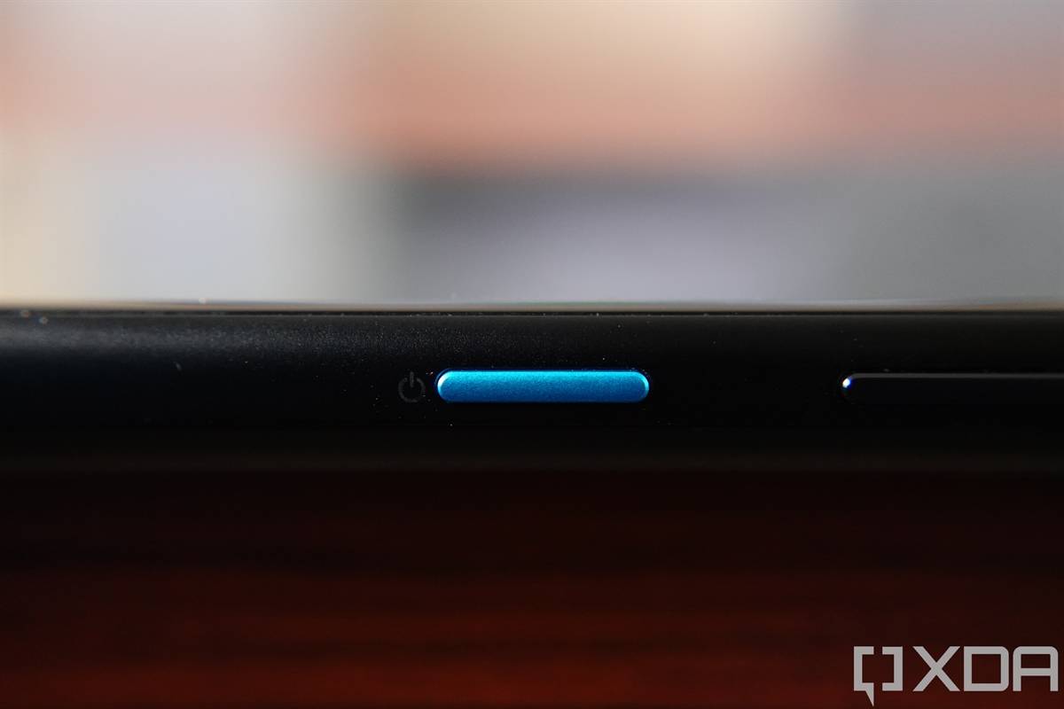 Close-up shot of the blue power button on the ASUS ZenFone 8