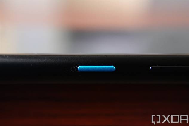Close-up shot of the blue power button on the ASUS ZenFone 8