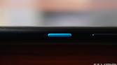 Close-up shot of the blue power button on the ASUS ZenFone 8