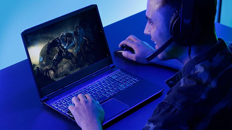 Smiling man gaming on Acer Predator Triton 300