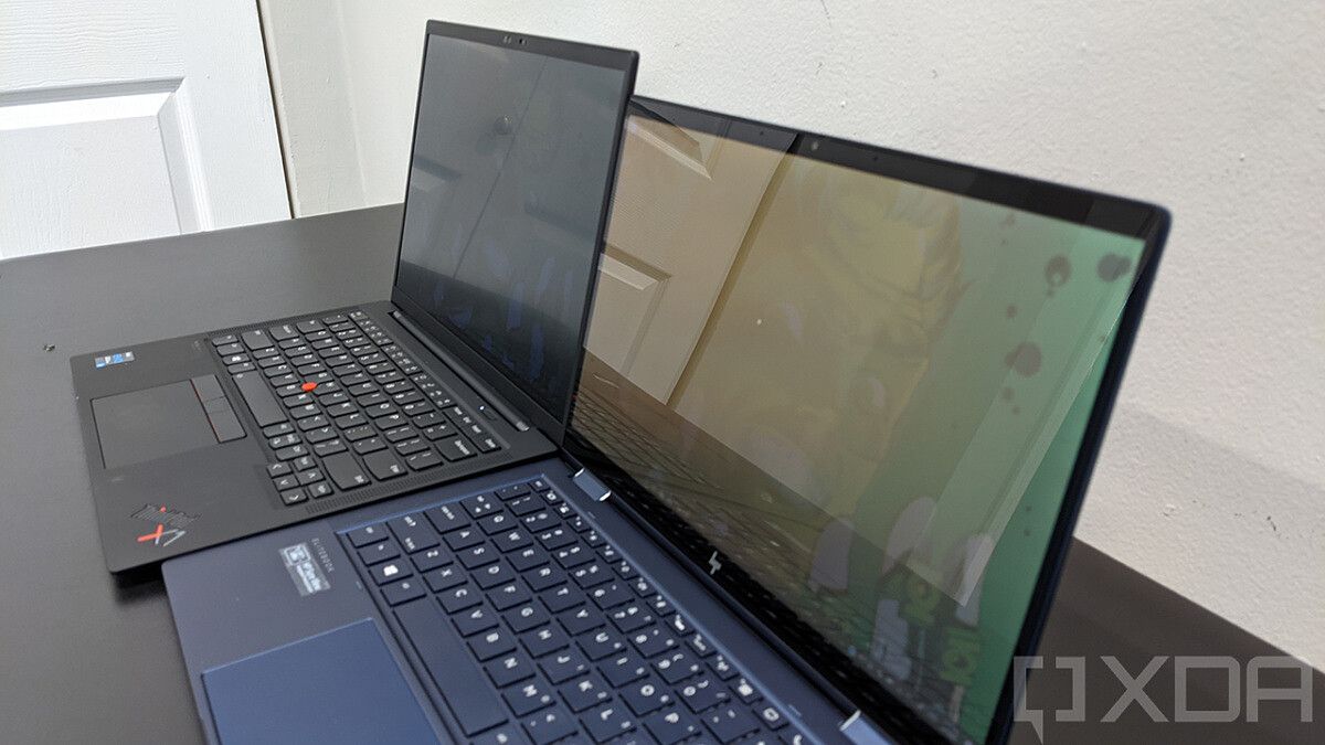 ThinkPad X1 Carbon next to HP Elite Dragonfly with privacy display on