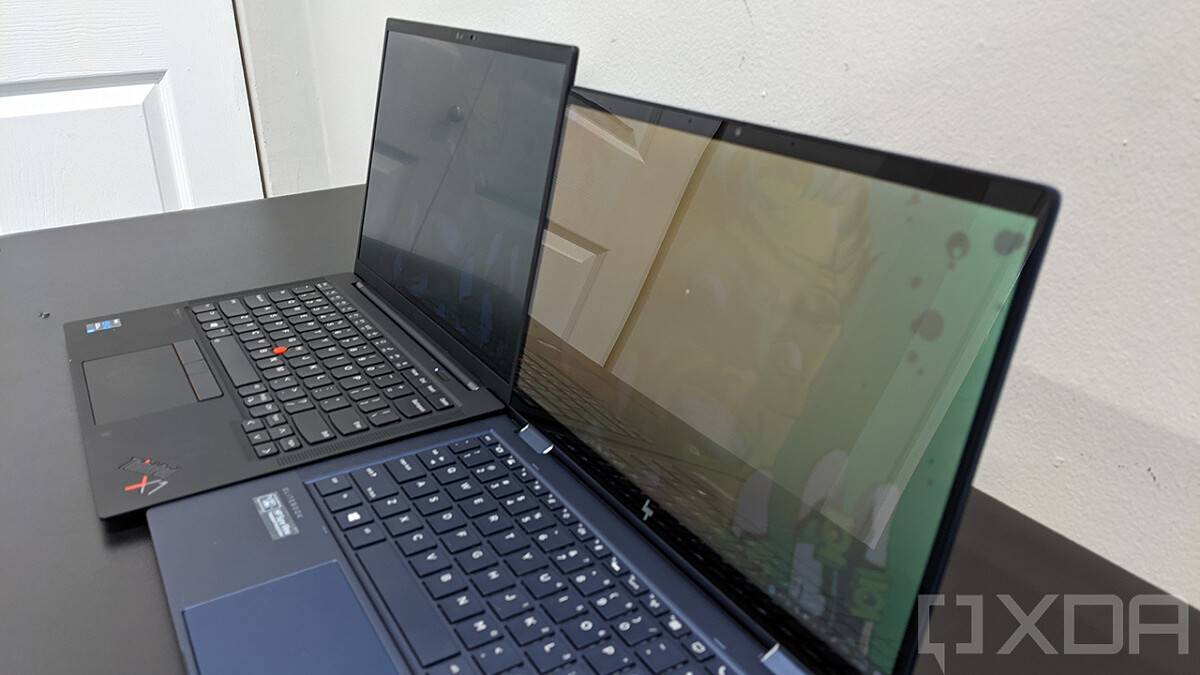 ThinkPad X1 Carbon next to HP Elite Dragonfly with privacy display on