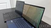 ThinkPad X1 Carbon next to HP Elite Dragonfly with privacy display on