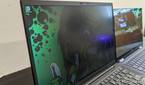 ThinkPad X1 Carbon next to HP Elite Dragonfly with privacy display on