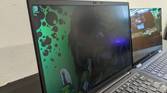 ThinkPad X1 Carbon next to HP Elite Dragonfly with privacy display on