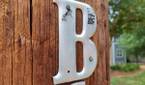 Photo of a letter 'B' on a wooden post