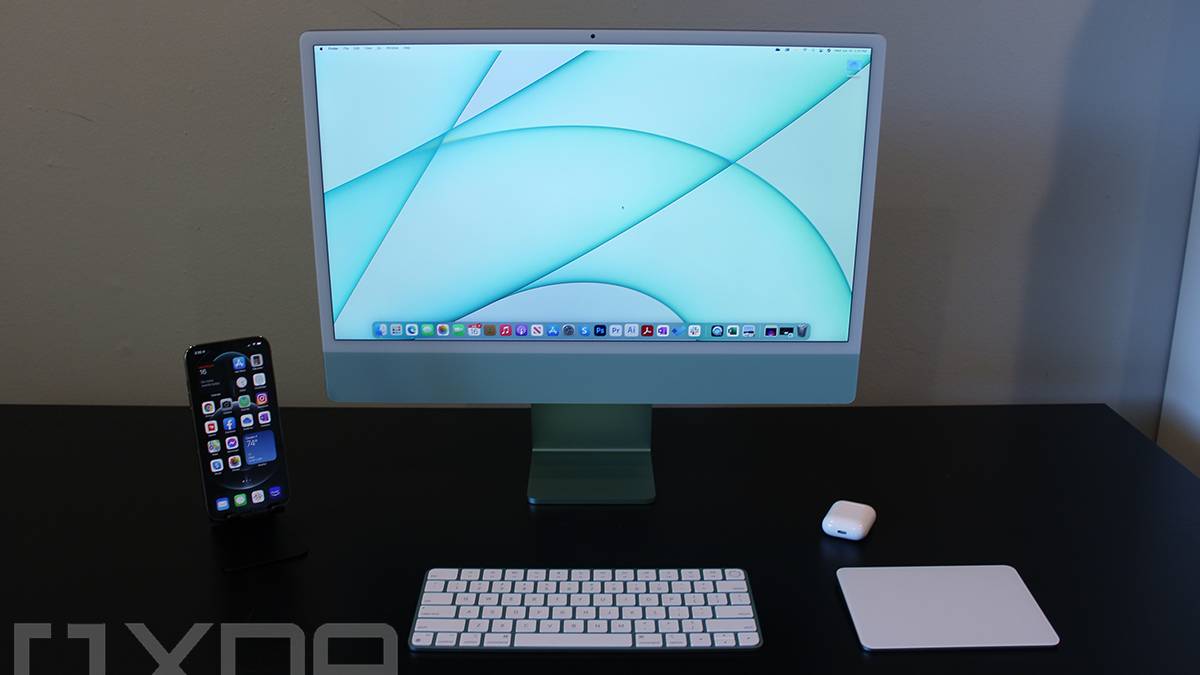 Front view of 24-inch iMac with keyboard, mouse, iPhone, and AirPods
