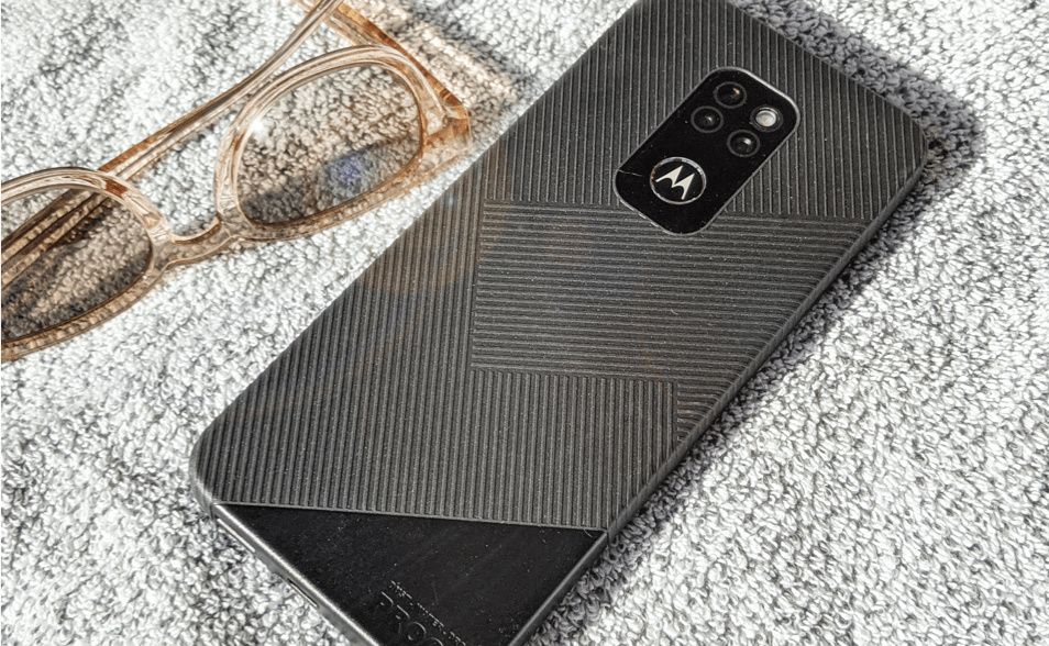 Motorola Defy lying beside a pair of glasses