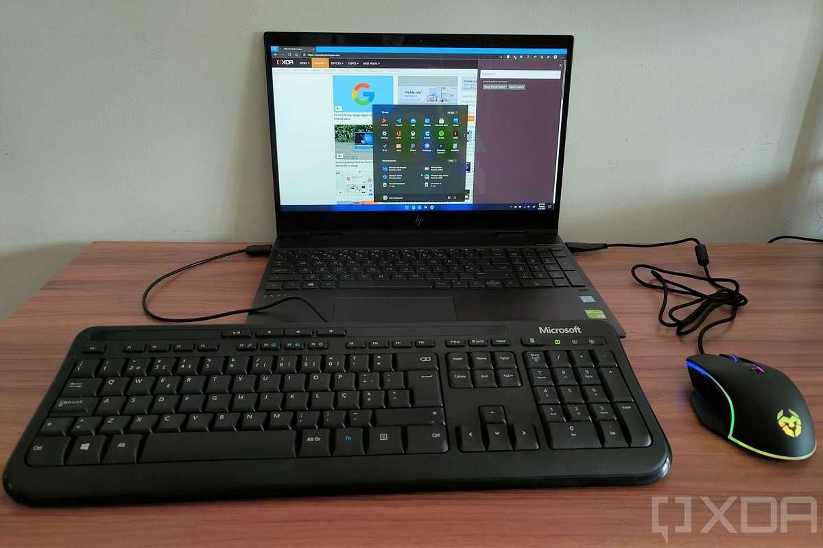 A USB keyboard and mouse plugged into a laptop running Windows 11