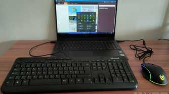 A USB keyboard and mouse plugged into a laptop running Windows 11