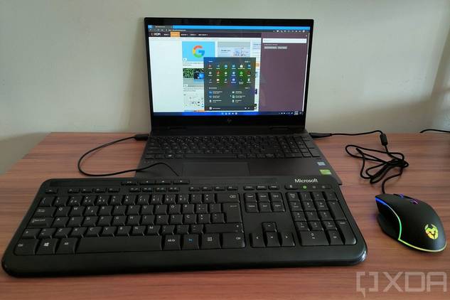 A USB keyboard and mouse plugged into a laptop running Windows 11