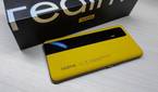 Realme GT dual-tone leather variant lying beside its box