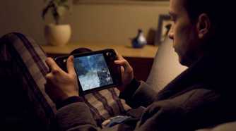 A man playing Doom on a Steam Deck