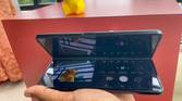 Samsung Galaxy Z Fold 3 in Flex Mode being used to take a photo of a toy from an awkward angle