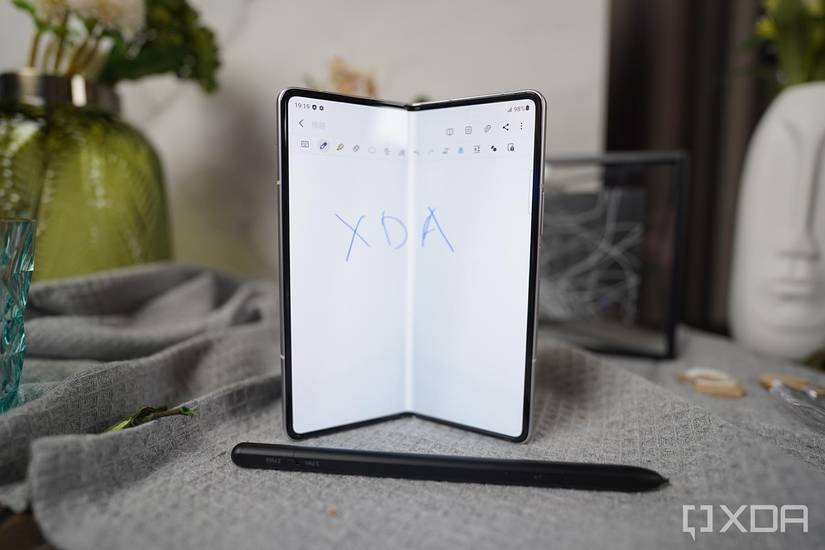 Galaxy Z Fold 3 folded halfway with an S-Pen Pro nearby