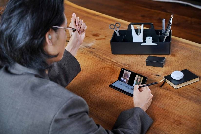 Samsung Galaxy Z Fold 3 being used in video call in Flex Mode, to take notes
