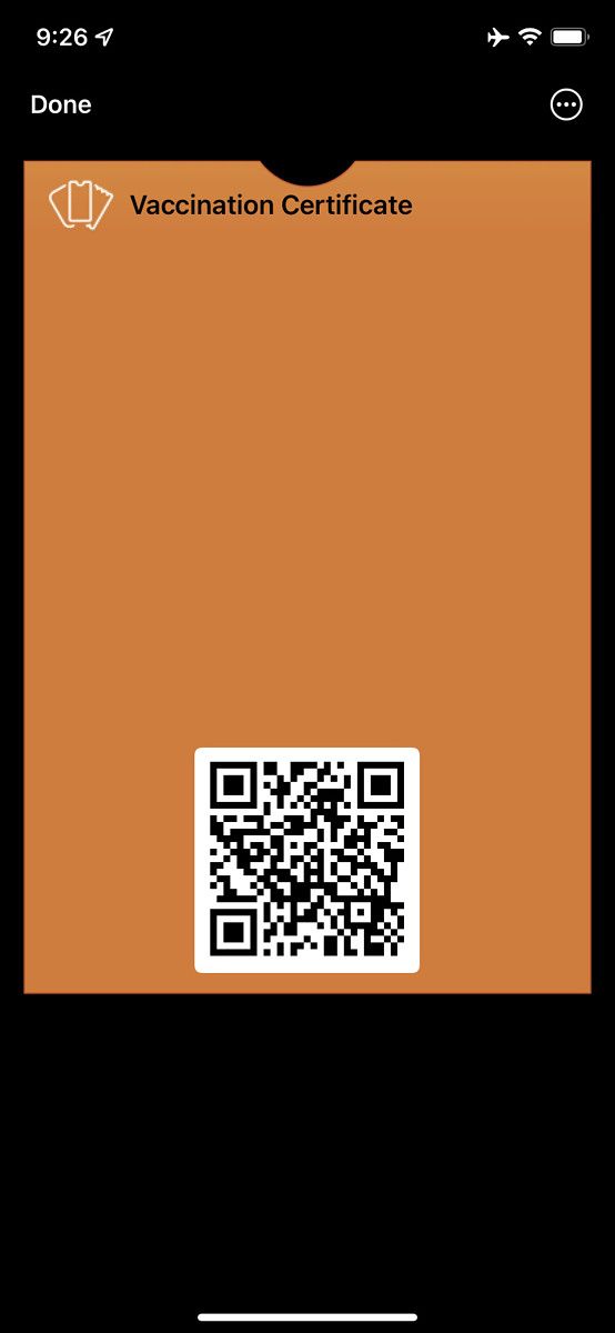 Mobile app screen showing QR code for vaccine certificate in Apple Wallet