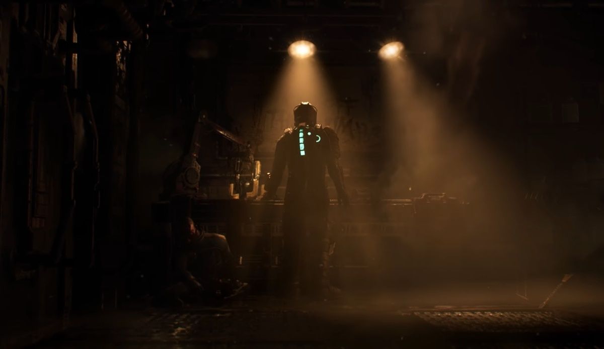 Isaac standing in a dimly lit room