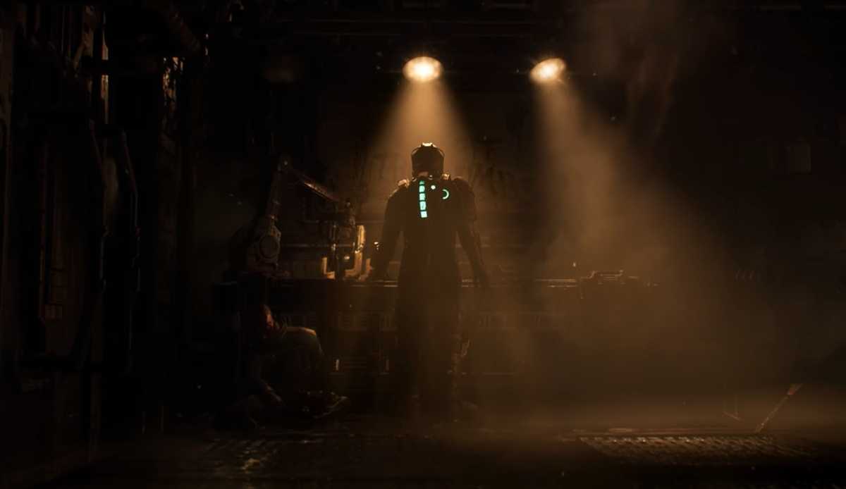 Isaac standing in a dimly lit room