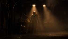Isaac standing in a dimly lit room