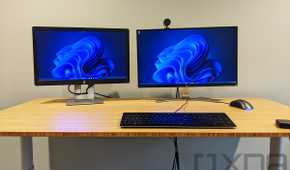 Wooden desk with keyboard and two monitors on top