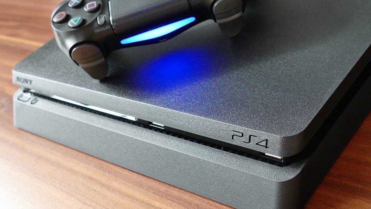 front of a playstation 4 with a controller on top, spine emulates the playstation 4
